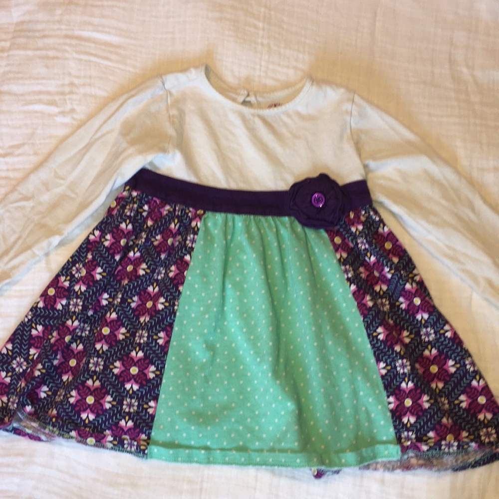 Long sleeved white, purple, and mint blouse.